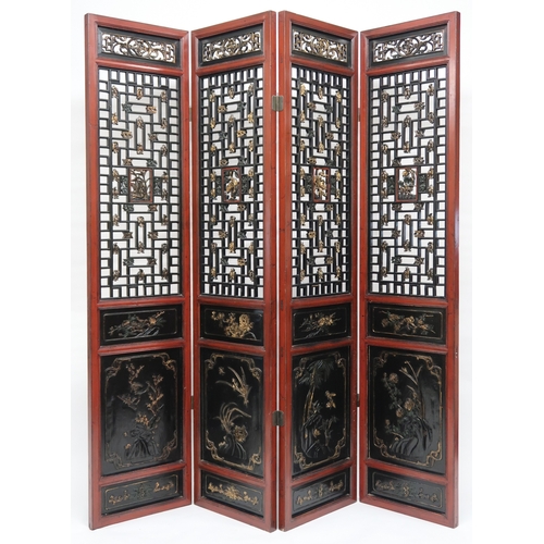 2029 - A 20TH CENTURY CHINESE RED AND BLACK LACQUERED FOUR FOLD ROOM DIVIDER each panel with carved pierced... 