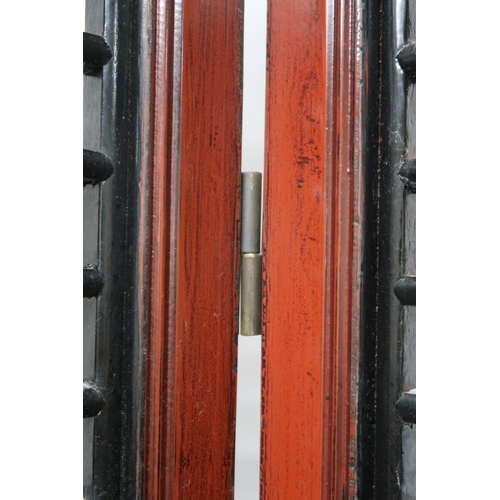 2029 - A 20TH CENTURY CHINESE RED AND BLACK LACQUERED FOUR FOLD ROOM DIVIDER each panel with carved pierced... 