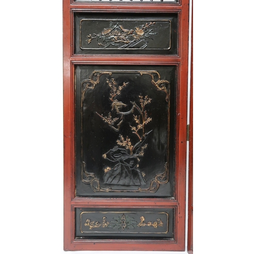 2029 - A 20TH CENTURY CHINESE RED AND BLACK LACQUERED FOUR FOLD ROOM DIVIDER each panel with carved pierced... 