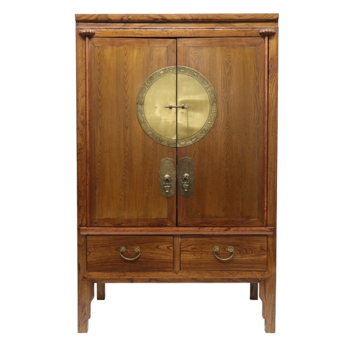 2026 - A 20TH CENTURY CHINESE ELM WEDDING CABINET with pair of doors mounted with brass plaque depicting an... 