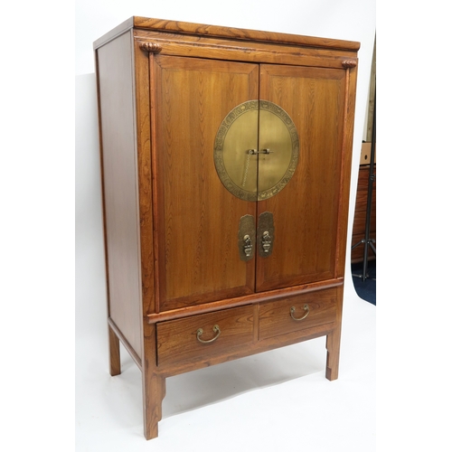 2026 - A 20TH CENTURY CHINESE ELM WEDDING CABINET with pair of doors mounted with brass plaque depicting an... 