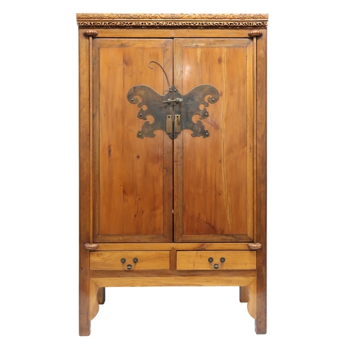 2027 - A 20TH CENTURY CHINESE HARDWOOD WEDDING CABINET with carved pierced frieze over pair of cabinet door... 