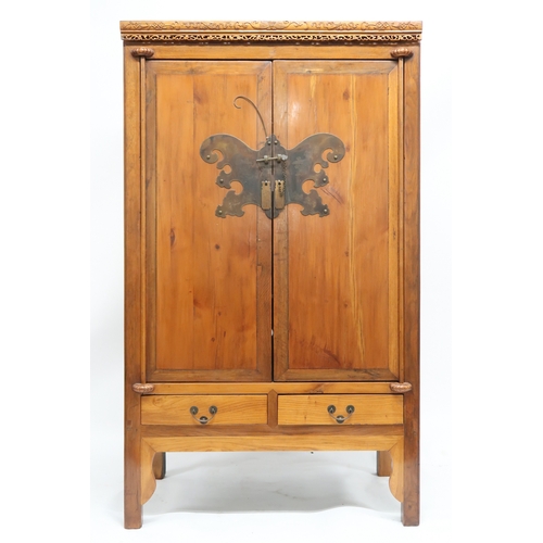 2027 - A 20TH CENTURY CHINESE HARDWOOD WEDDING CABINET with carved pierced frieze over pair of cabinet door... 