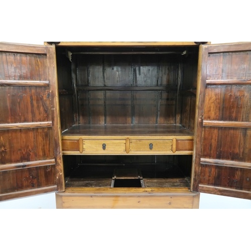 2028 - A 20TH CENTURY CHINESE HARDWOOD WEDDING CABINET with carved pierced frieze over pair of doors mounte... 