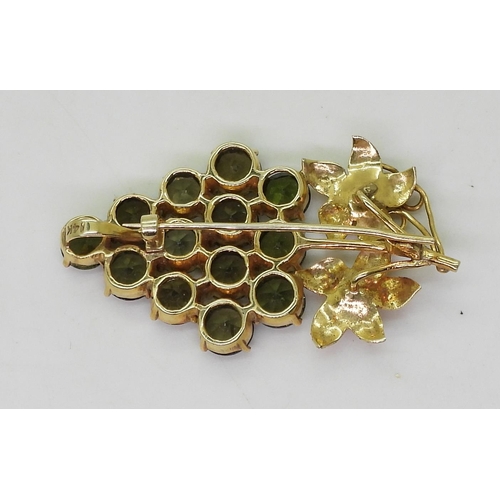 825 - A 14k gold bunch of grapes pendant brooch, set with green gemstones, weight 6.5gms