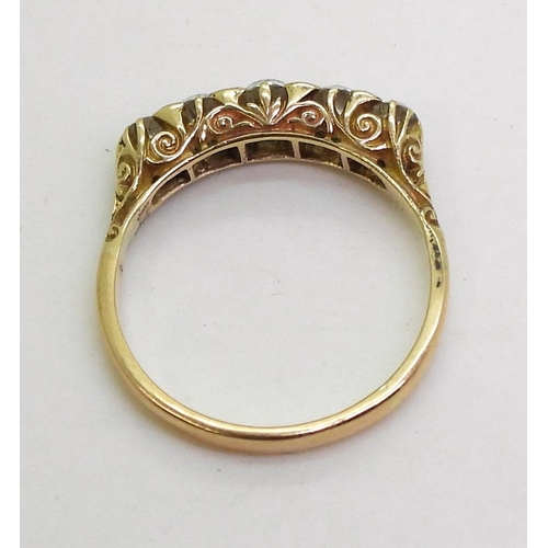 837 - A bright yellow metal scrolled mount ring set with five old cut diamonds, with an estimated approx d... 