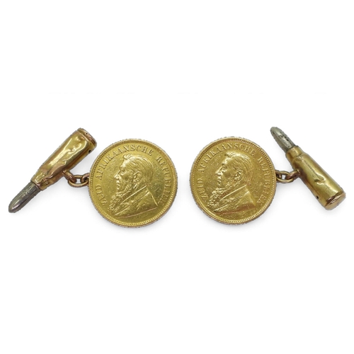 704 - A pair of unusual cufflinks made from two 1/2 pond coins with 9ct gold chains and bullet design back... 