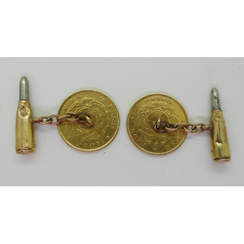 704 - A pair of unusual cufflinks made from two 1/2 pond coins with 9ct gold chains and bullet design back... 