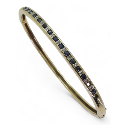 718 - A 9ct gold sapphire and diamond accent bangle (one sapphire missing) weight 9.9gms