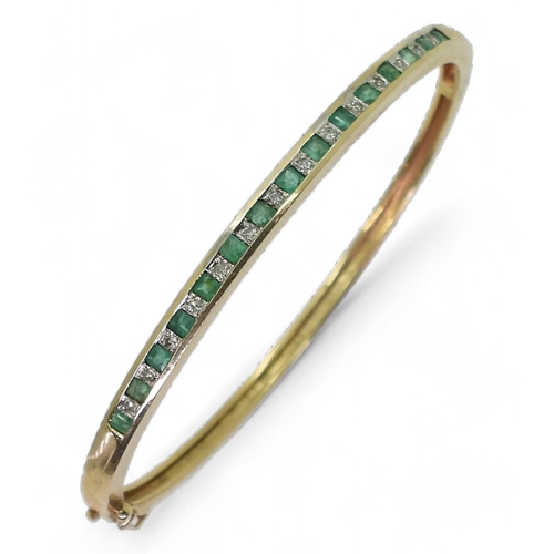 719 - A 9ct gold emerald and diamond accent bangle, weight 9.5gms