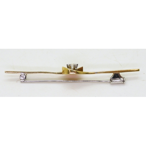 724 - An 18ct gold diamond set bar brooch, set with an 0.15ct diamond solitaire, weight 4.1gms