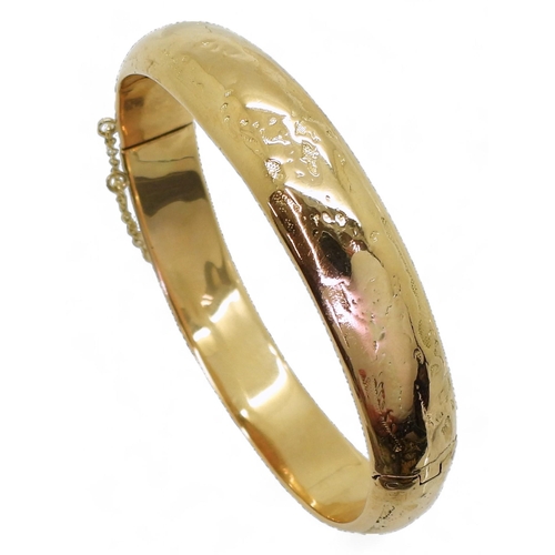 727 - A yellow metal heavy bangle, stamped but unreadable, inner diameter 6cm, weight 28.7gms