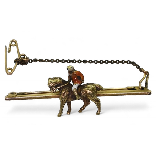 729 - A 15ct gold horse and rider bar brooch, length 5cm, weight 8.3gms