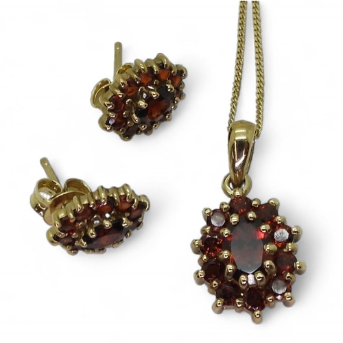 764 - A 9ct gold garnet cluster pendant and earring set , weight together 4.2gms