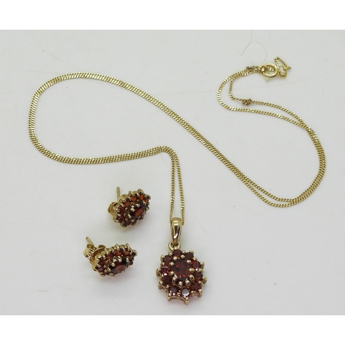 764 - A 9ct gold garnet cluster pendant and earring set , weight together 4.2gms