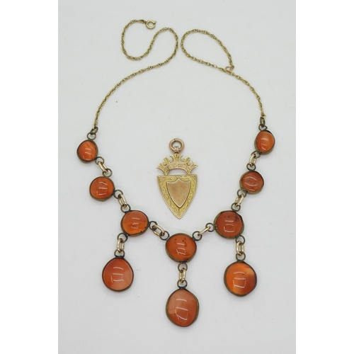 765 - A 9ct gold medallion, together with a carnelian necklace, with a partial yellow metal rope chain, we... 