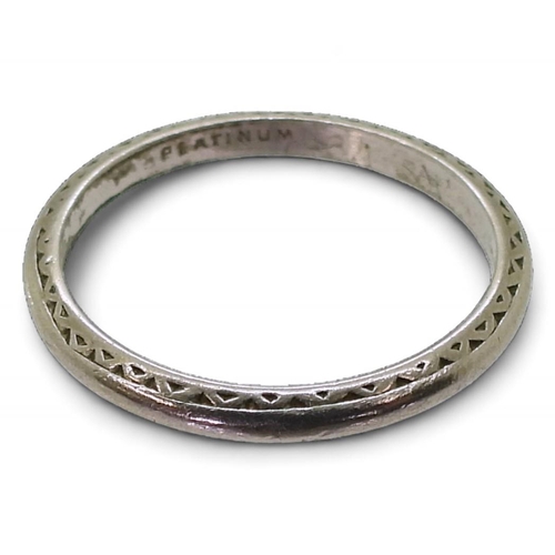 791 - A platinum wedding ring, with engraved pattern, size L, weight 2.5gms