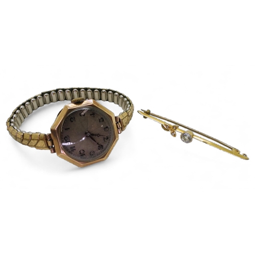 797 - A 9ct cased ladies Cyma watch head with a gold plated strap and a yellow metal gem set brooch, weigh... 