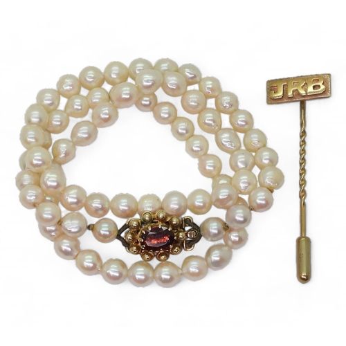 799 - A string of baroque pearls, length 42cm, with a 9ct gold garnet set clasp, together with a 9ct gold ... 