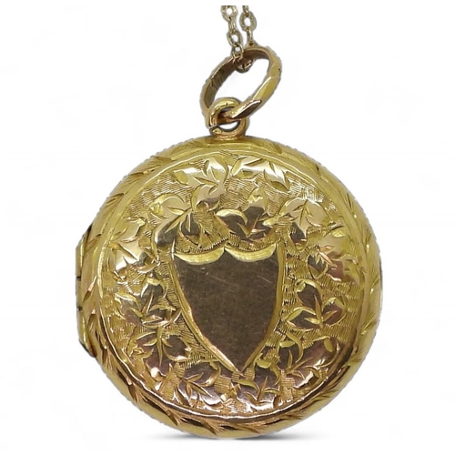 819 - A 9ct gold engraved locket hallmarked Birmingham 1909, diameter 2cm, length of chain 44cm, weight to... 