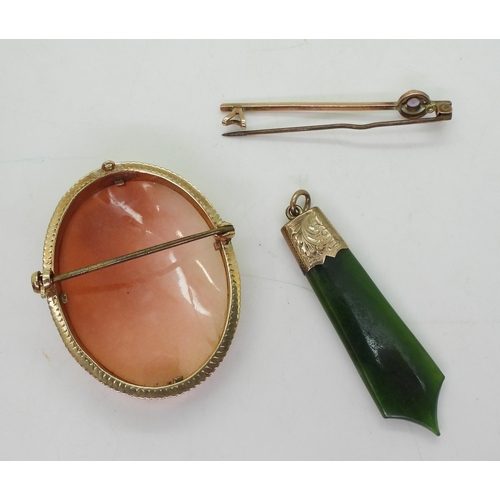 832B - A 9ct gold mounted cameo brooch, New Zealand hardstone pendant and a 9ct amethyst brooch, weight all... 