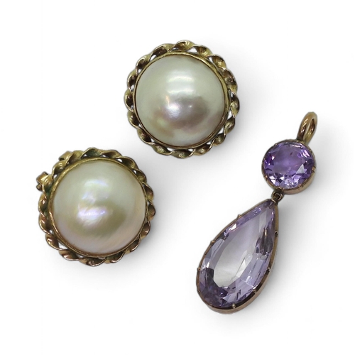 834A - A pair of 9ct gold mounted mabe pearl earrings, and a yellow metal mounted amethyst pendant, weight ... 