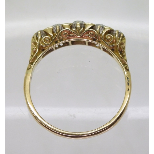 837 - A bright yellow metal scrolled mount ring set with five old cut diamonds, with an estimated approx d... 