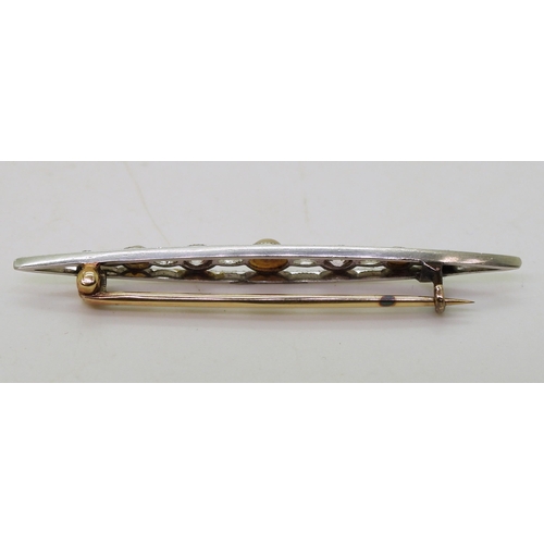 838 - A yellow and white metal old cut diamond and pearl pierced bar brooch, weight 2.3gms, retailed by P.... 