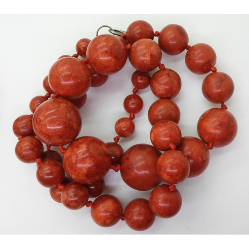 840 - Four coral beaded necklaces, together with a further red bead example, possibly red jasper