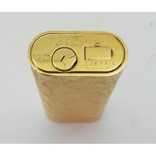 844 - A Gold plated lighter, marked 'Le Must de Cartier', with original box, paperwork and guarantee, toge... 