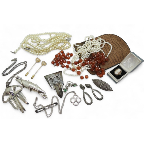 862 - Two craftsman made white metal brooches and an amethyst set pendant, a long string of facet cut carn... 