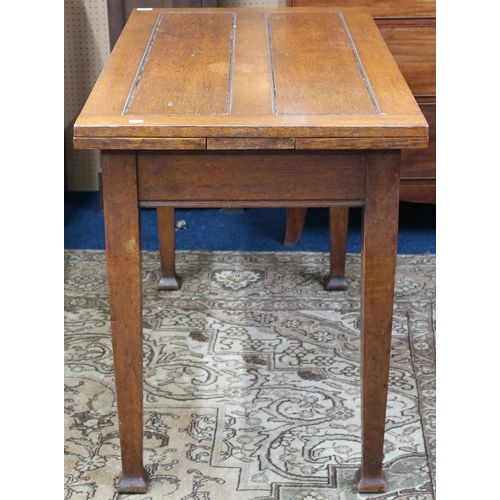 14 - An early 20th century oak Arts & Crafts pull out kitchen table on square tapering supports, 76cm... 