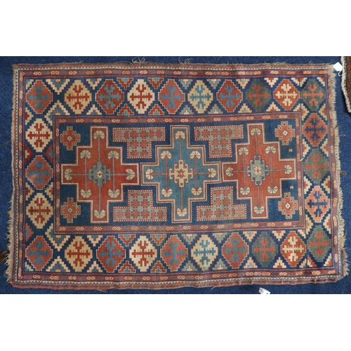 17 - A blue ground Balouch rug with multi-coloured geometric patterned ground within multi-coloured borde... 