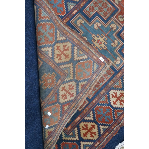 17 - A blue ground Balouch rug with multi-coloured geometric patterned ground within multi-coloured borde... 