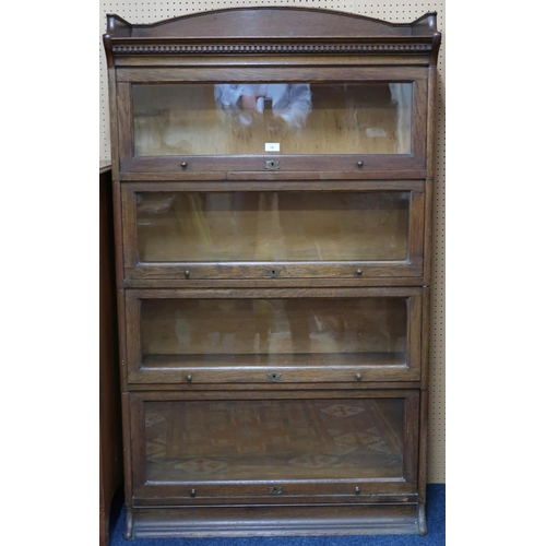 18 - A 20th century oak four tier sectional bookcase with glazed fall front doors, 153cm high x 88cm wide... 