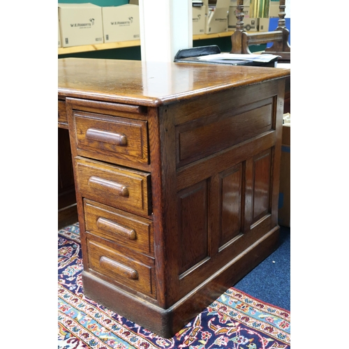 2 - An early 20th century oak Globe Wernicke pedestal desk with central drawer flanked by four drawer pe... 