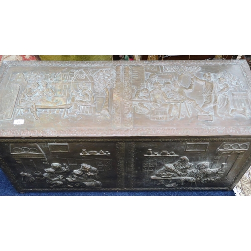 23 - An early 20th century blanket chest decoratively embossed with tavern scenes, 57cm high x 116cm wide... 