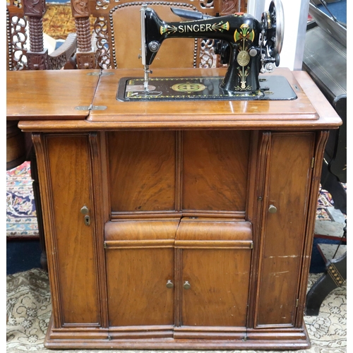 26 - A 20th century mahogany cased Singer parlour sewing machine, 79cm high x 81cm wide x 45cm deep