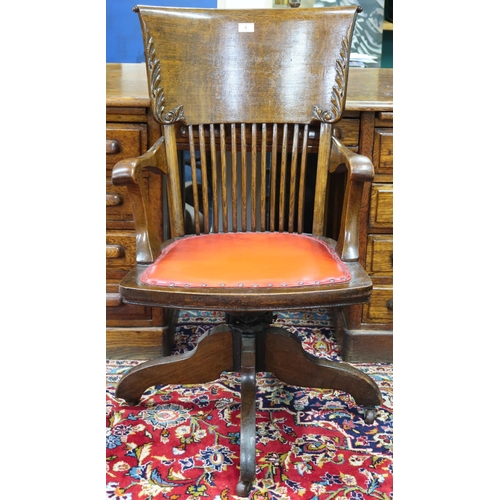 3 - An early 20th century oak Johnston Chair Co, comb back swivel desk chair with leather upholstered se... 