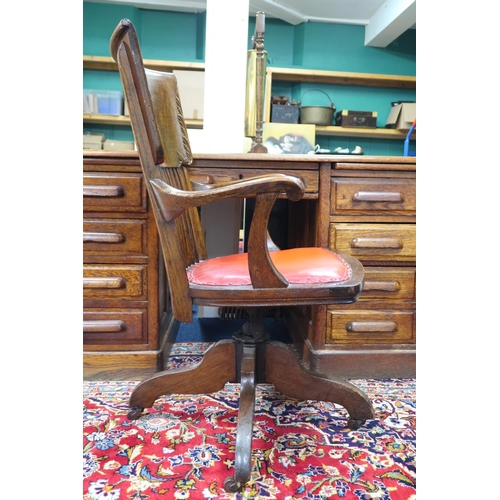 3 - An early 20th century oak Johnston Chair Co, comb back swivel desk chair with leather upholstered se... 