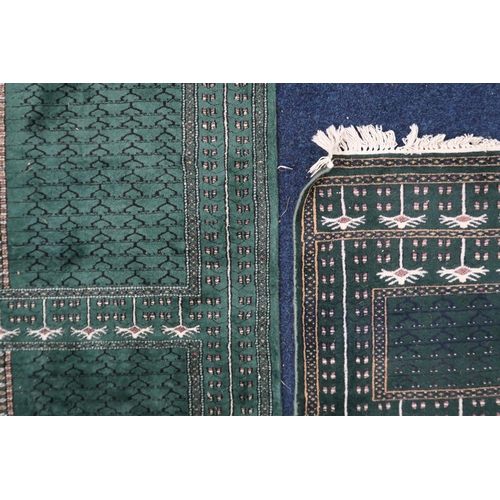 30 - A lot comprising a green ground Persian style rug with panel design within geometric border, 181cm l... 