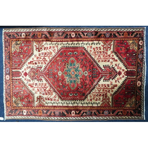 38 - A cream ground Hamadan rug with red central medallion and matching spandrels on geometric patterned ... 