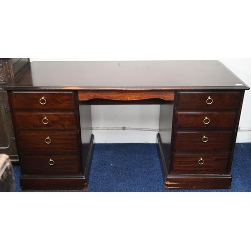 41 - A mid 20th century Stag style pedestal desk with twinned four drawer pedestals on plinth bases, 77cm... 