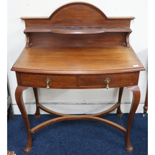 46 - An early 20th century mahogany bow fronted hall table with shelved gallery back over two drawers on ... 