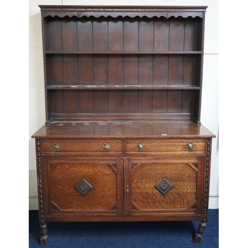 47 - An early 20th century oak dresser with two tier plate rack back on base with two drawers over pair o... 