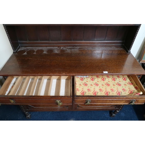 47 - An early 20th century oak dresser with two tier plate rack back on base with two drawers over pair o... 