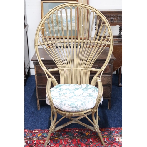 54 - A 20th century wicker peacock style armchair with floral upholstered cushion, 135cm high x 83cm wide... 