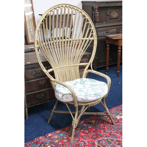 54 - A 20th century wicker peacock style armchair with floral upholstered cushion, 135cm high x 83cm wide... 