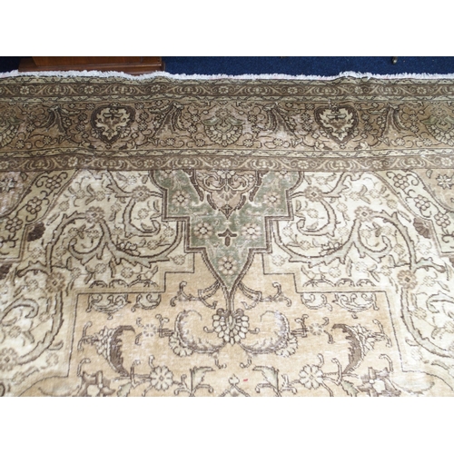 6 - A large beige ground Tabriz carpet with darker central medallion and spandrels on floral/foliate pat... 