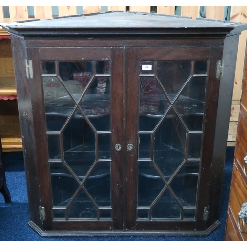 64 - A 19th century stained oak two door astragal glazed corner cabinet, 106cm high x 107cm wide 